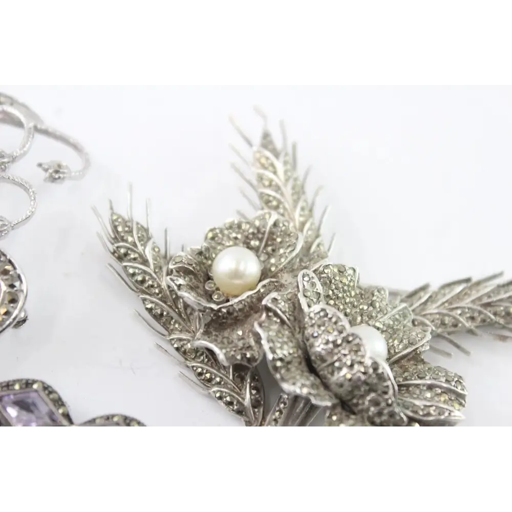Silver floral brooch with a pearl