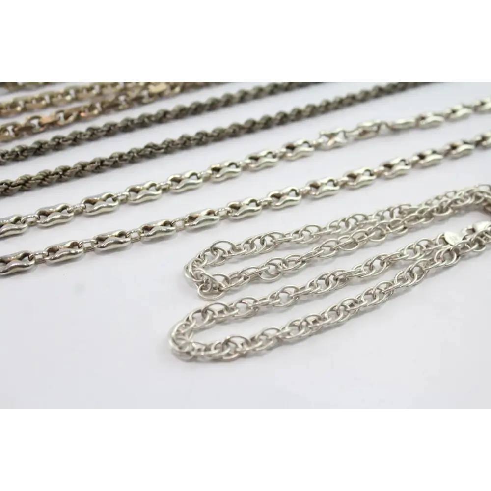 Silver chains of different styles on a white background