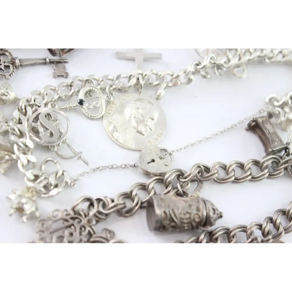 Silver charm bracelets on a white background