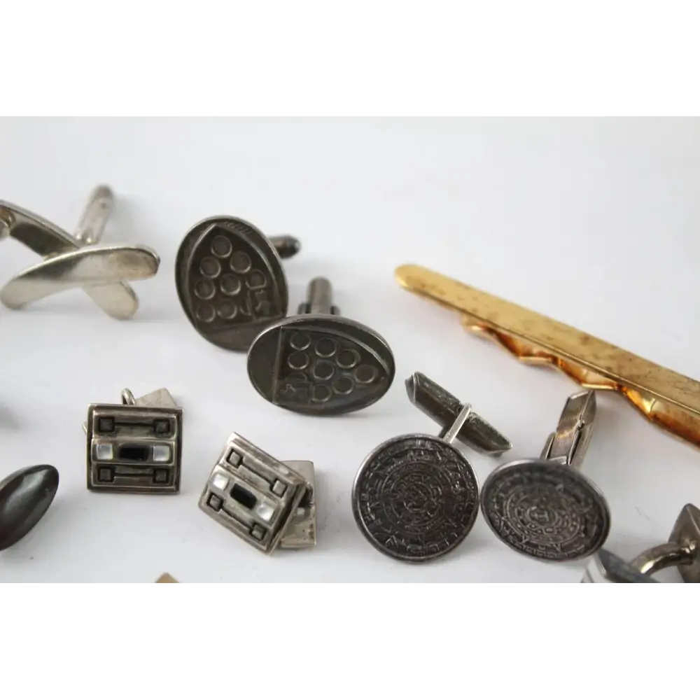 Collection of vintage-style cufflinks on a white background
