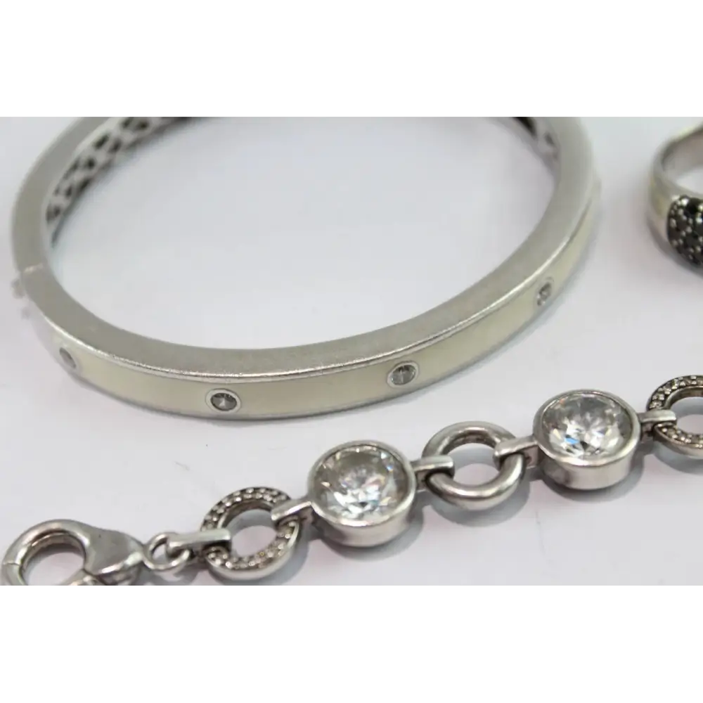 Silver bracelet with clear gemstones on a white background