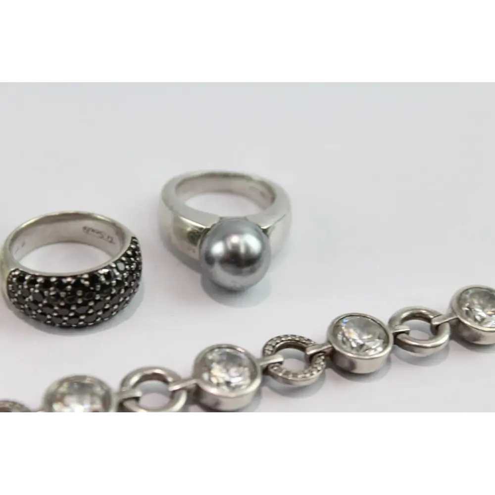 Silver rings and bracelet on a white background
