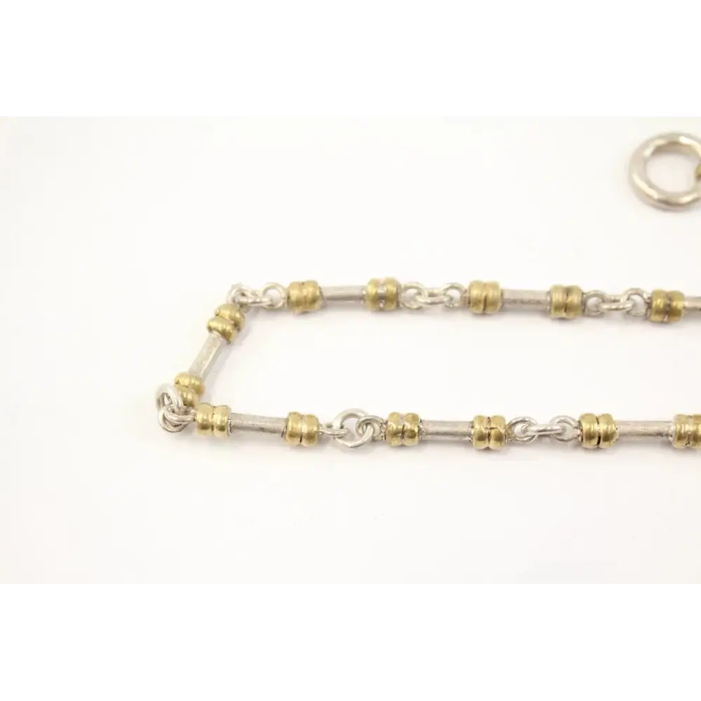 Gold and silver chain necklace on a white background