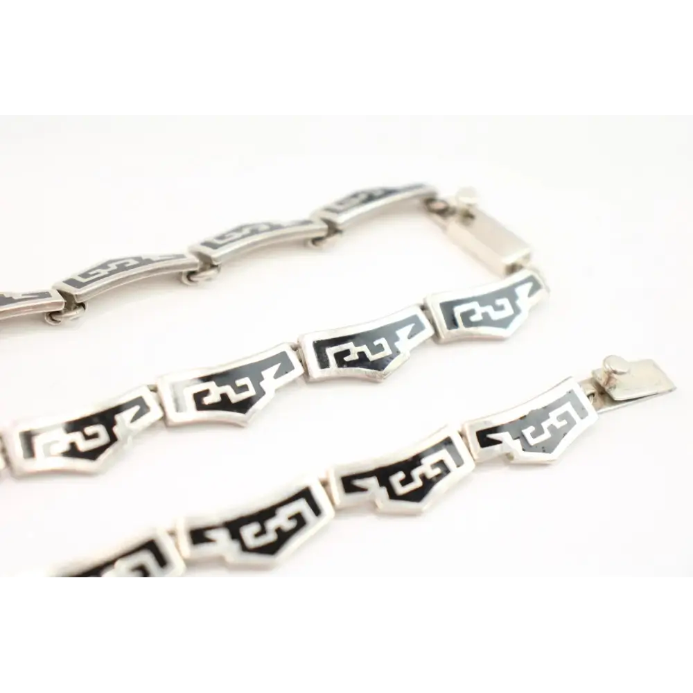 Silver bracelet with black geometric patterns