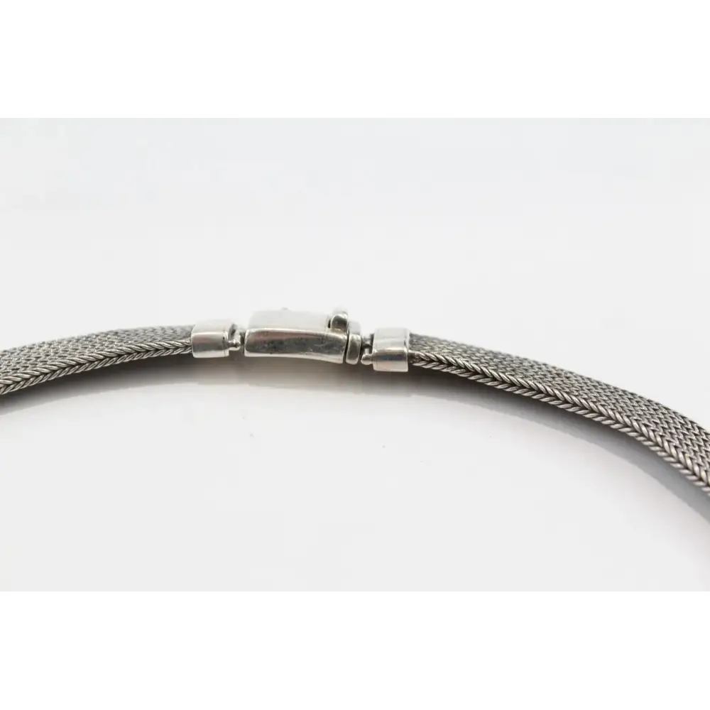 Silver braided necklace on a white background