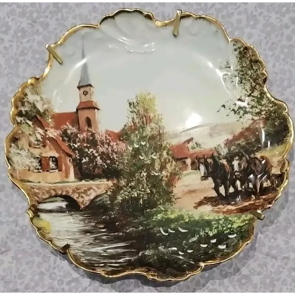 Decorative plate with a scenic village and horse-drawn