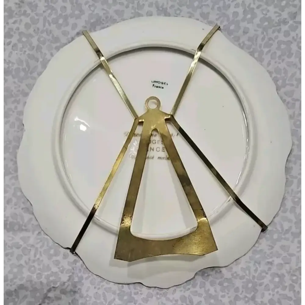 Decorative plate with gold geometric design on a textured gray background
