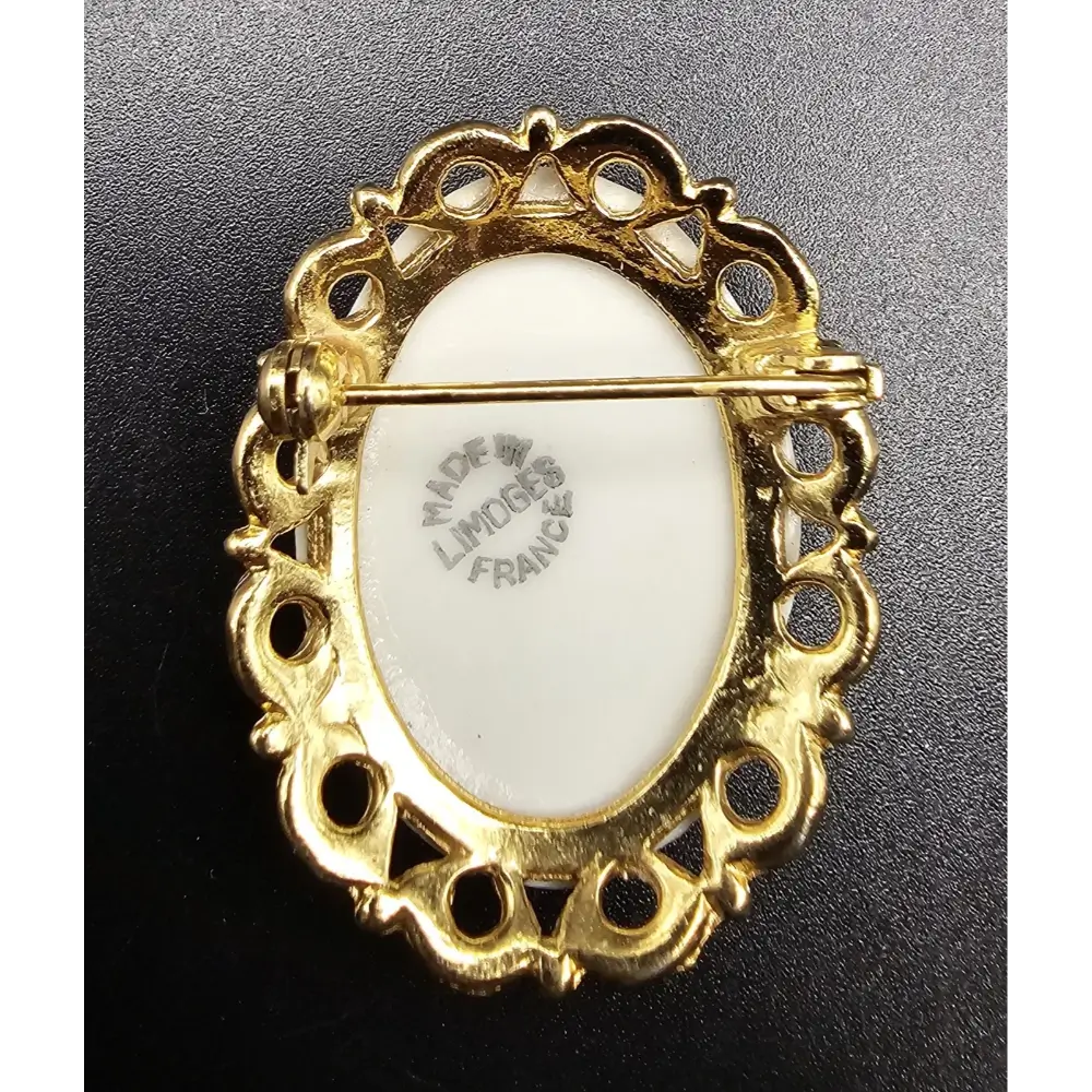 Gold brooch with white center
