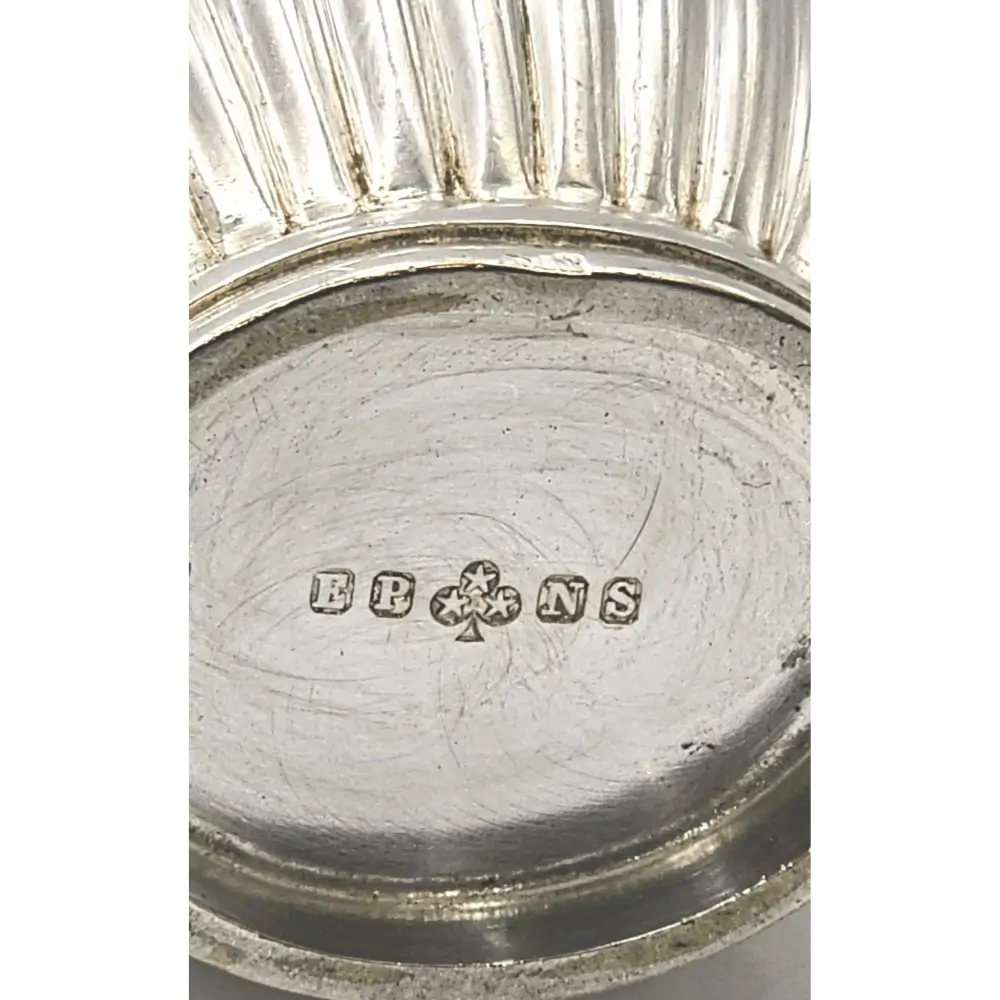 Close-up of a silver object with 'EBONS' branding