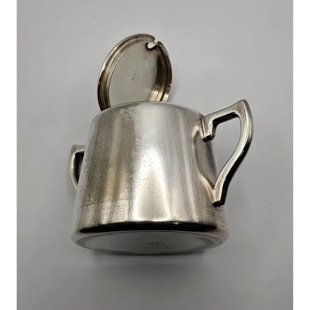 Silver pitcher with a handle on a gray background