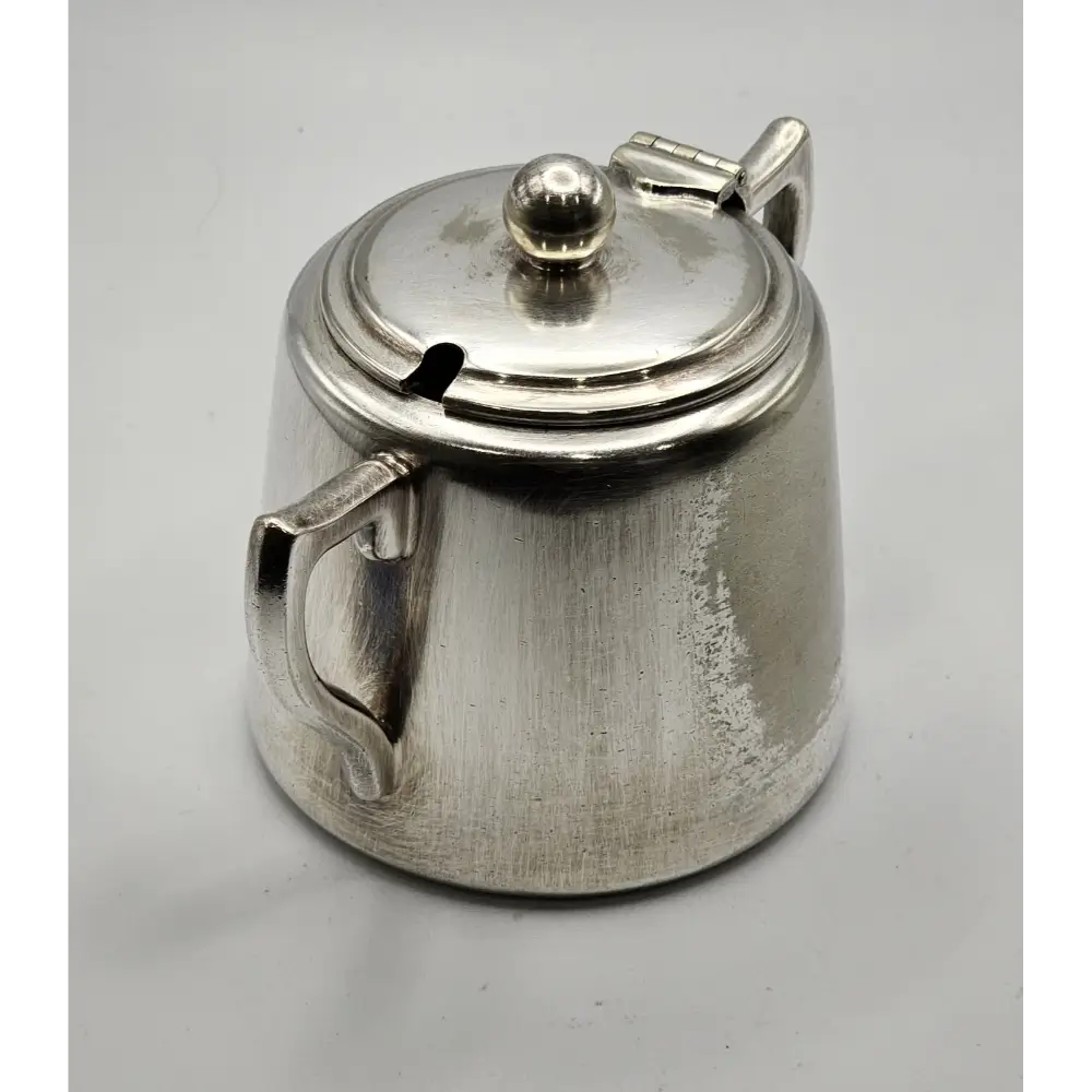 Silver teapot on a light gray background
