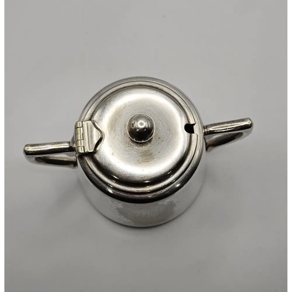 Silver teapot on a gray background