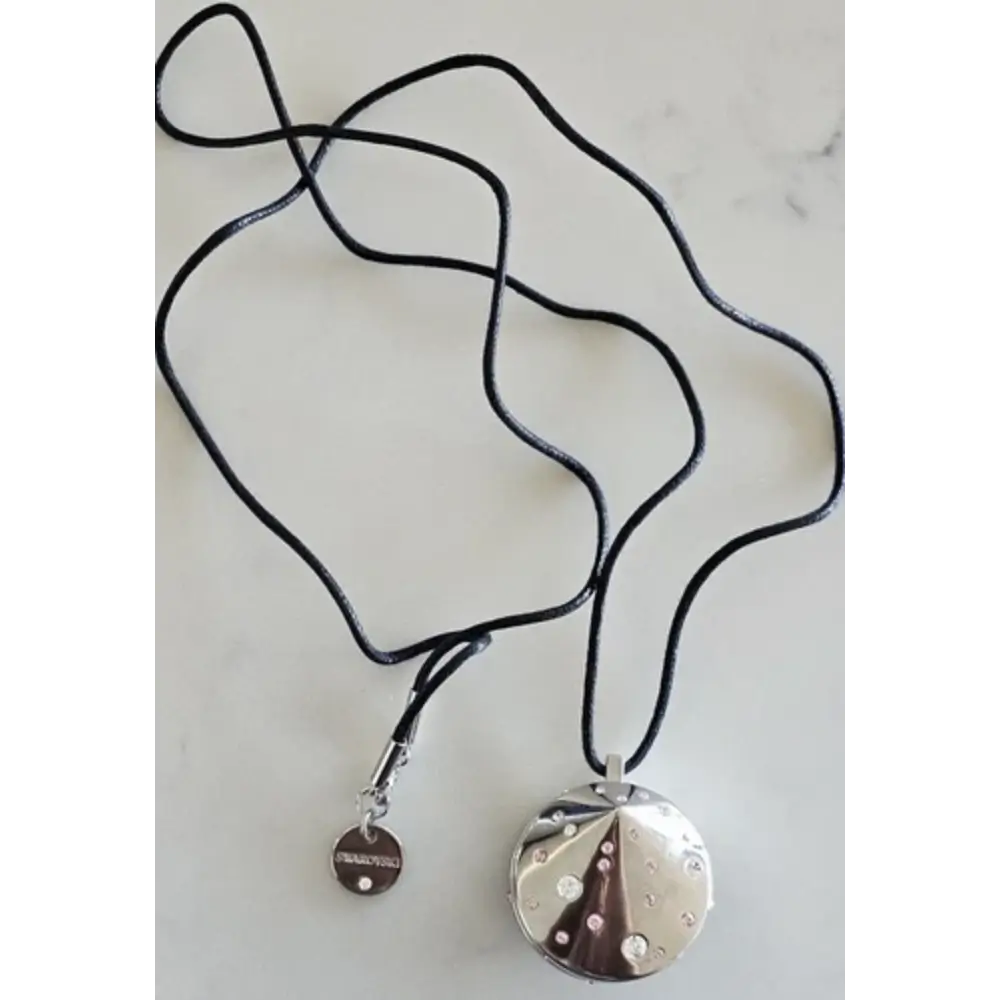 Necklace with a black cord and silver pendant