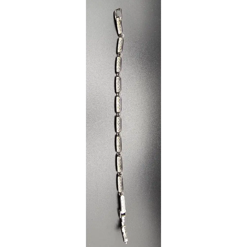 Silver bracelet with clear stones on a gray background