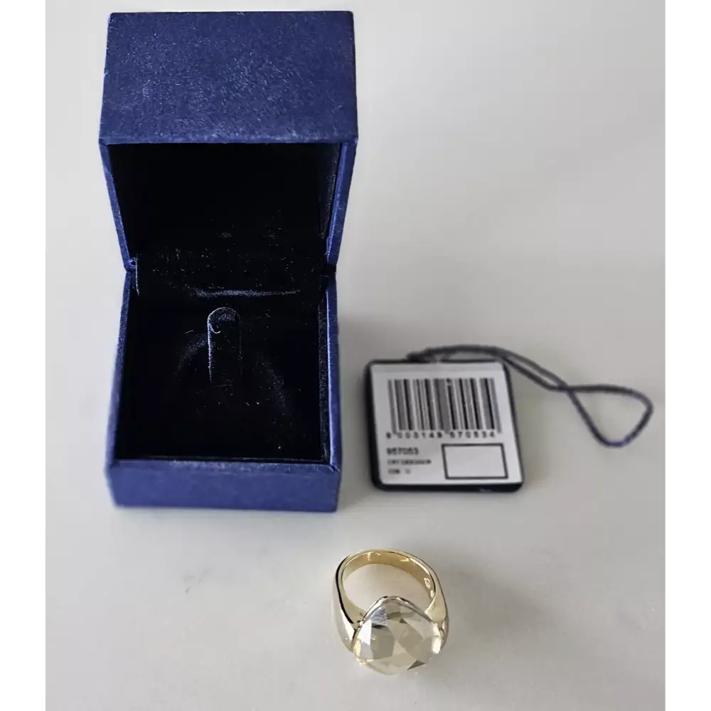 Gold ring with a blue box and barcode tag