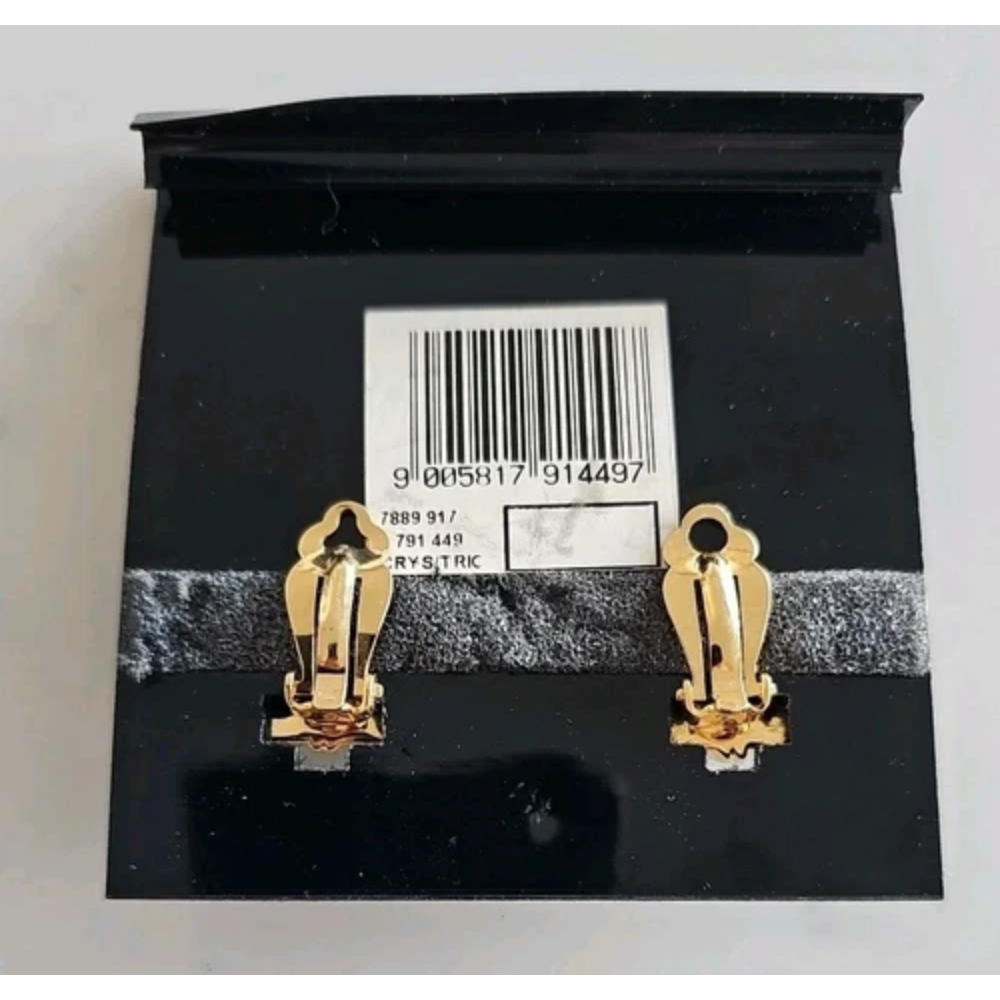 Gold earrings on a black card with a barcode and text