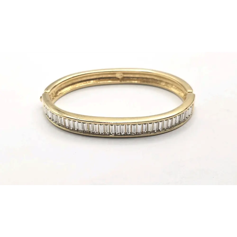 Gold Bangle with diamond accents on a white background