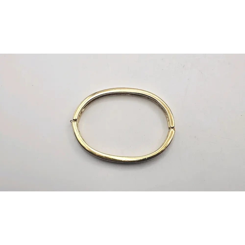 Gold Bangle on a light gray background