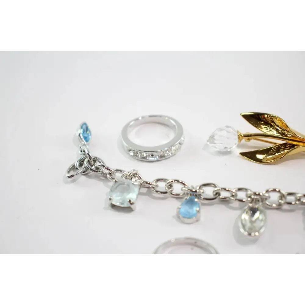 Silver bracelet with gemstone charms on a white background