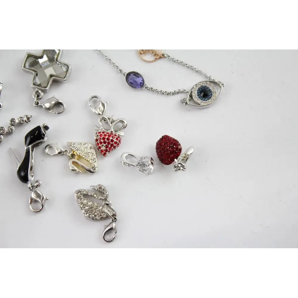 Collection of various jewelry pendants on a light gray background