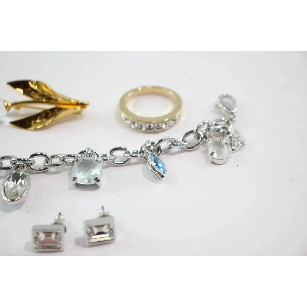 Collection of jewelry including a bracelet, ring, and earrings on a white background