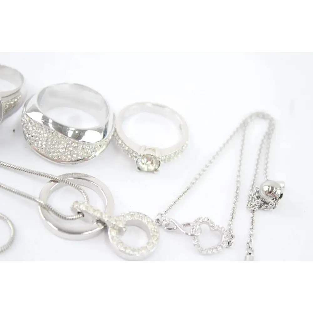 Collection of silver jewelry including necklaces and rings