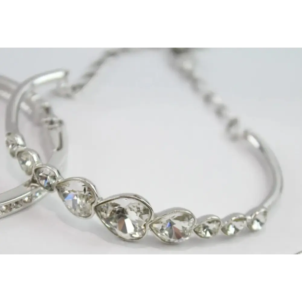 Silver bracelet with teardrop-shaped crystals on a white background