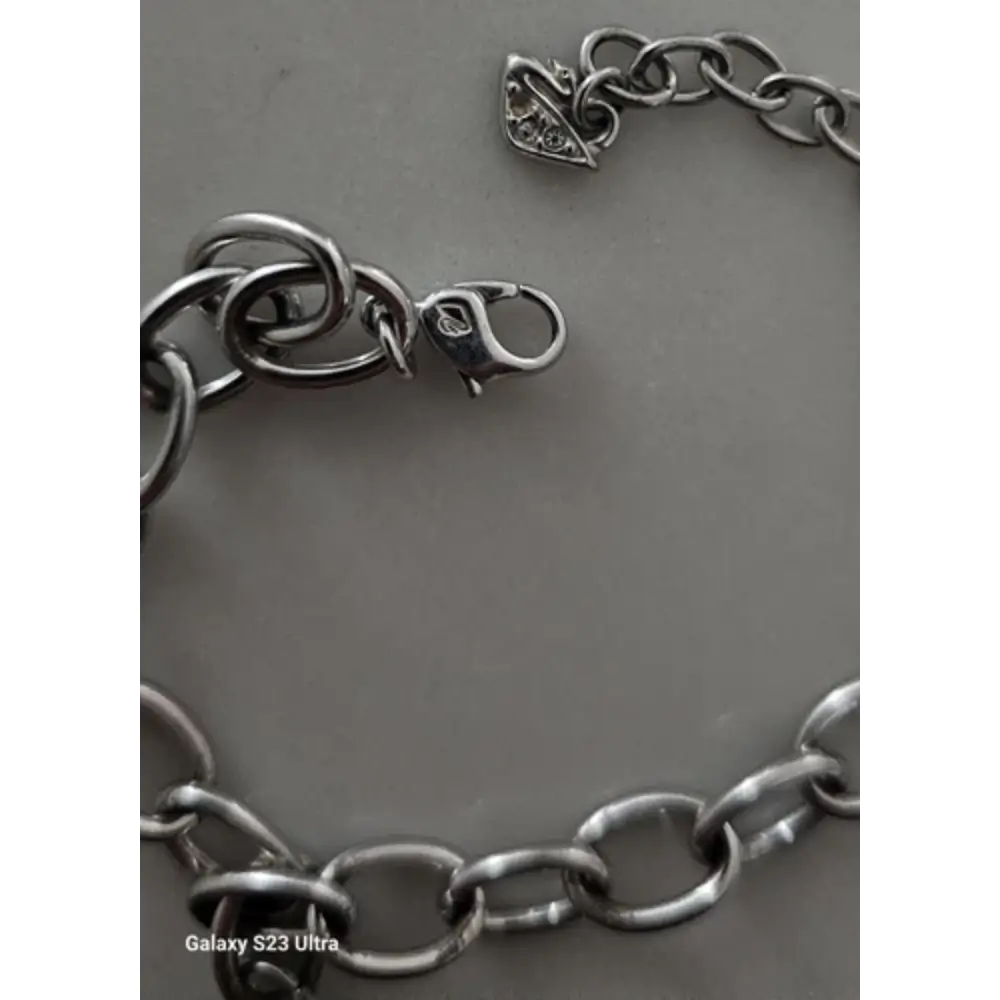 Silver chain bracelet on a gray background