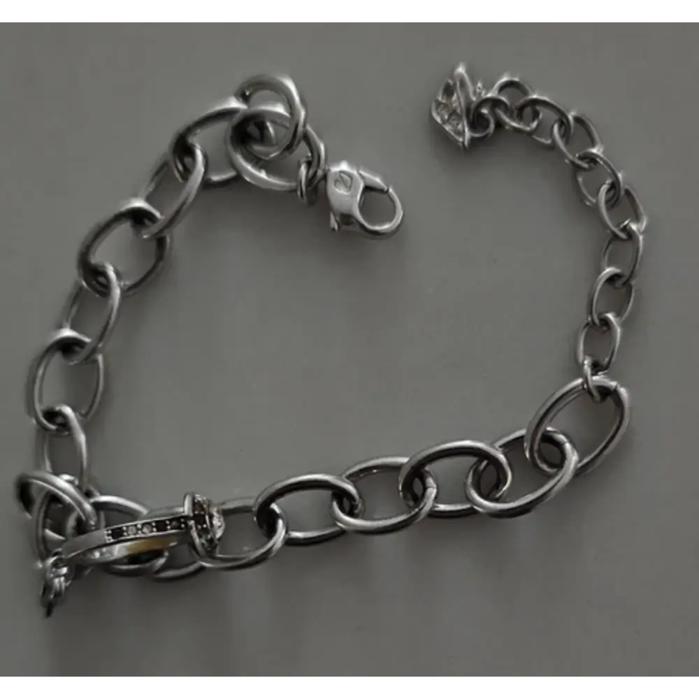 Silver chain bracelet on a gray background