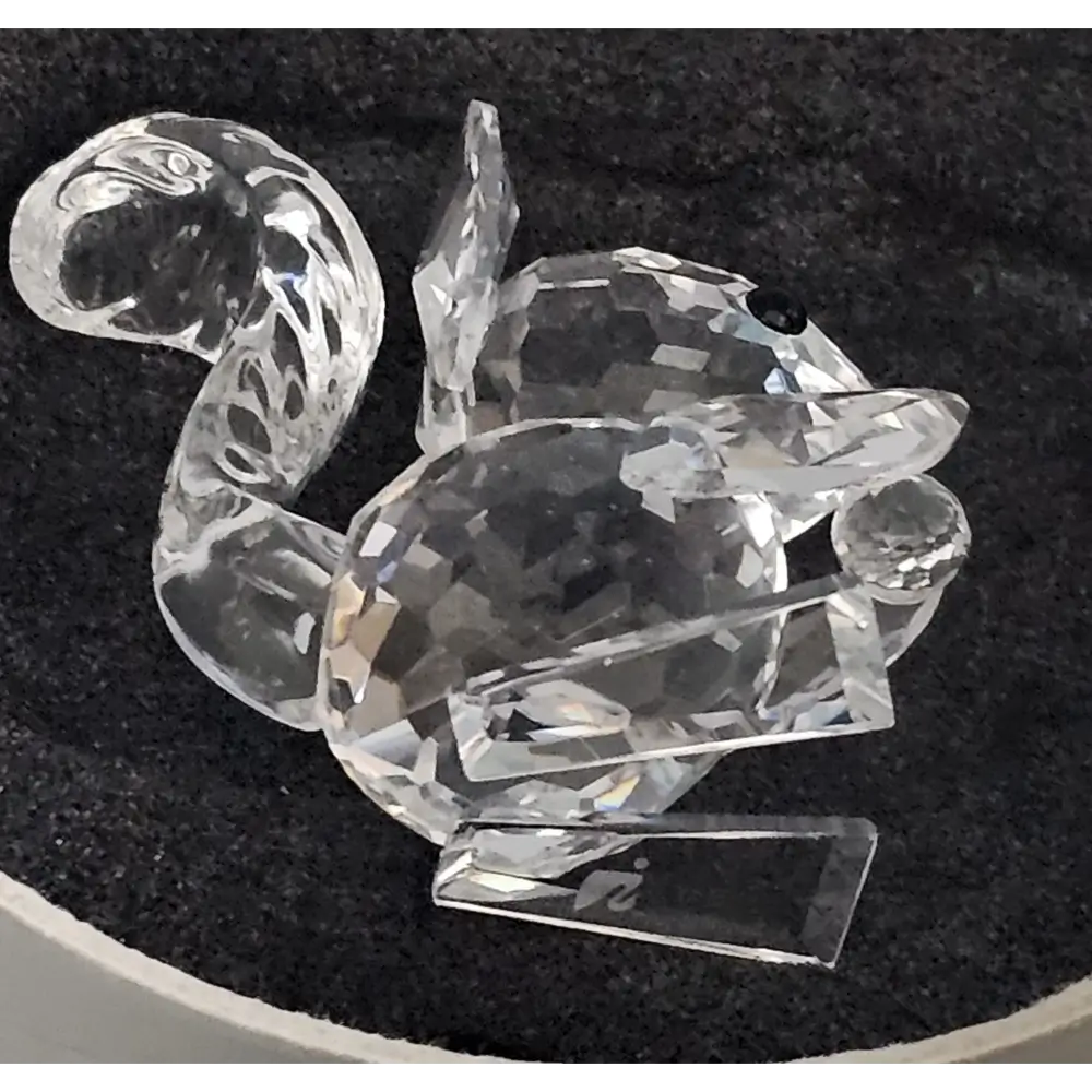 Crystal duck figurine on a black background