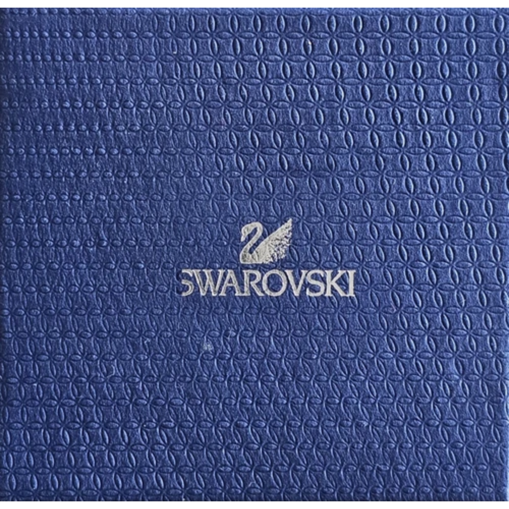 Blue textured surface with Swarovski logo