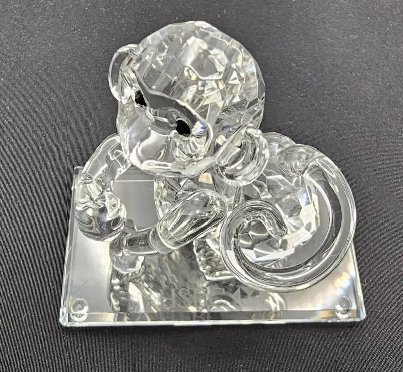 Crystal monkey figurine on a dark background