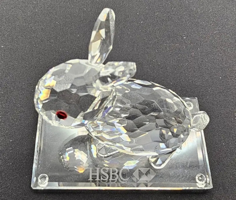 Crystal rabbit figurine with 'HSBC' branding on a black background
