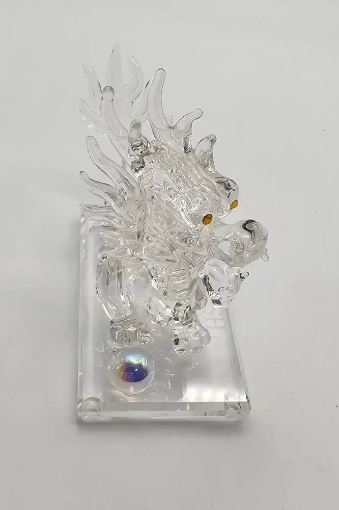 Clear glass dragon figurine on a white background