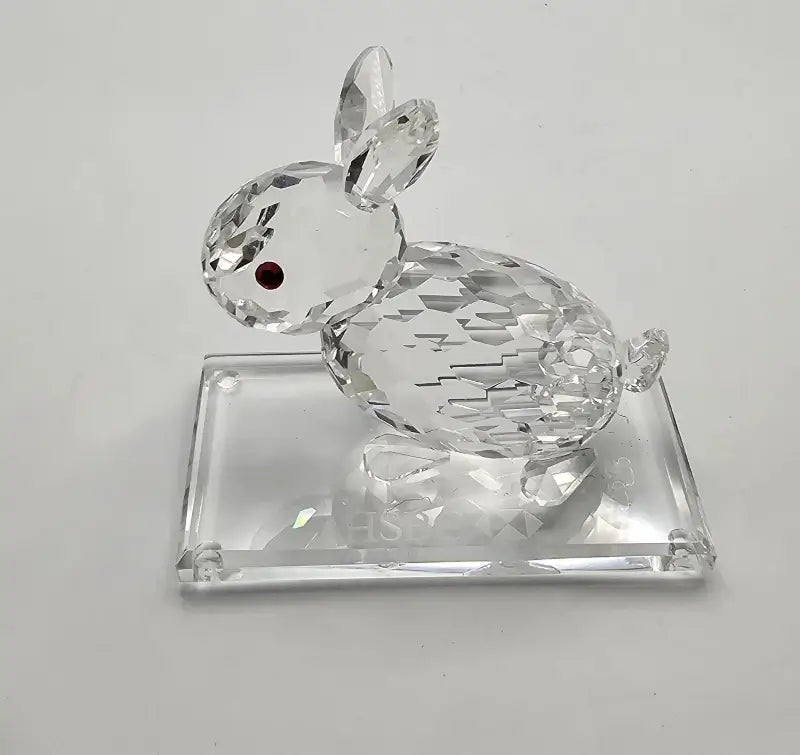 Crystal rabbit figurine on a clear base against