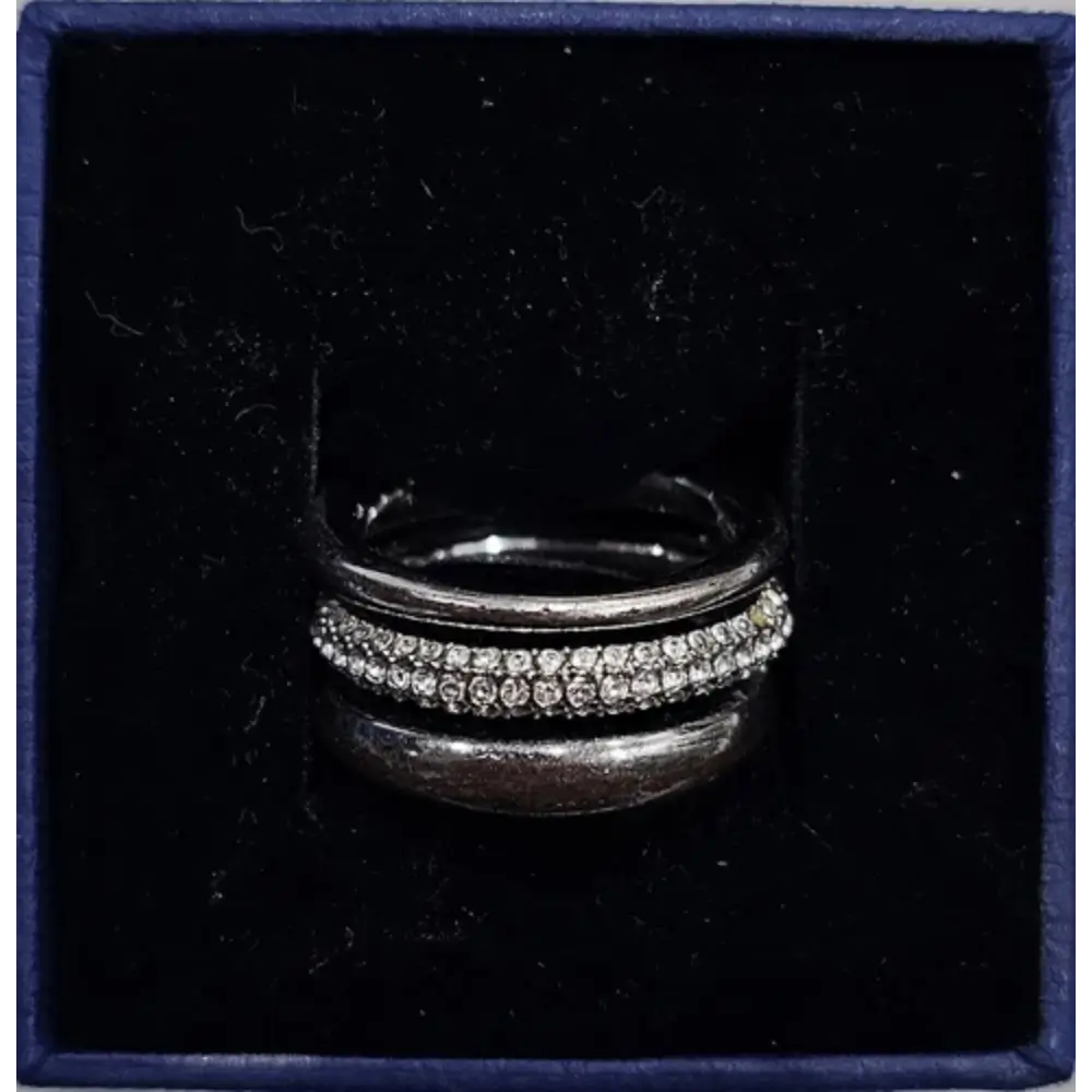 Silver ring with gemstones in a dark blue box