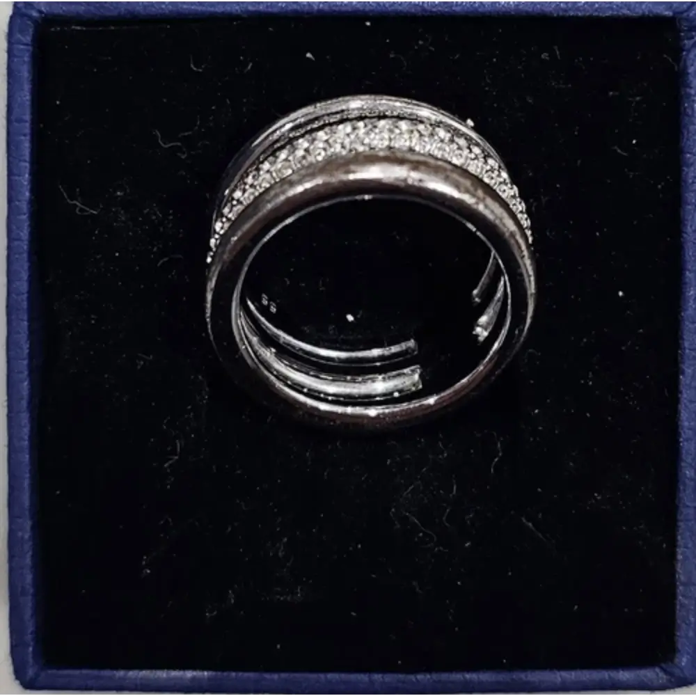 Silver ring with gemstones in a black box