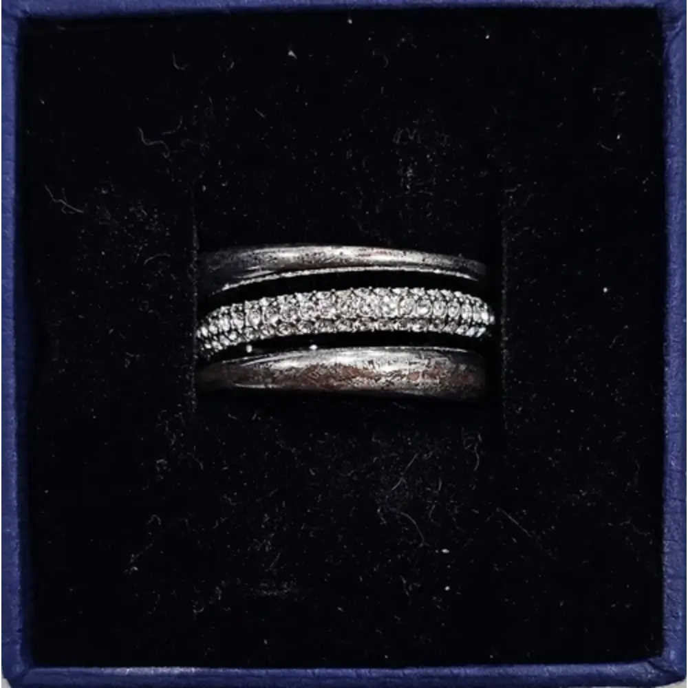 Silver ring with embedded stones in a black box
