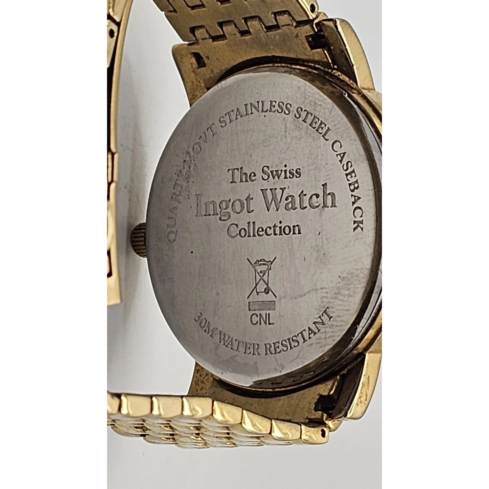 Back view of a gold watch with 'The Swiss Ingot Watch Collection' engraving