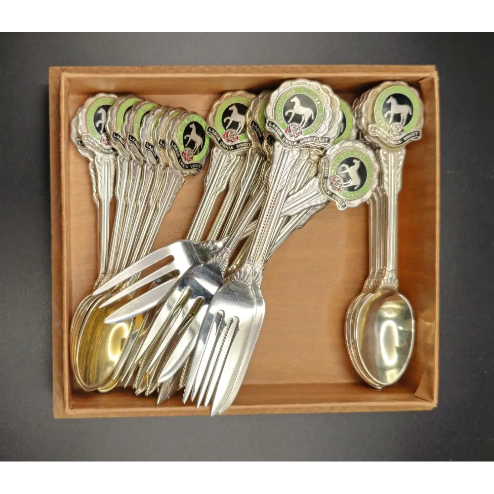 Set of silver cutlery with panda design handles in a wooden box