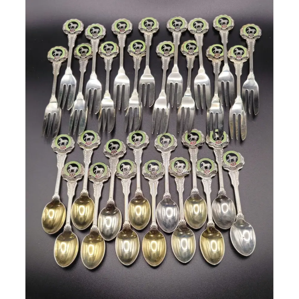 Set of silver spoons and forks with decorative handles