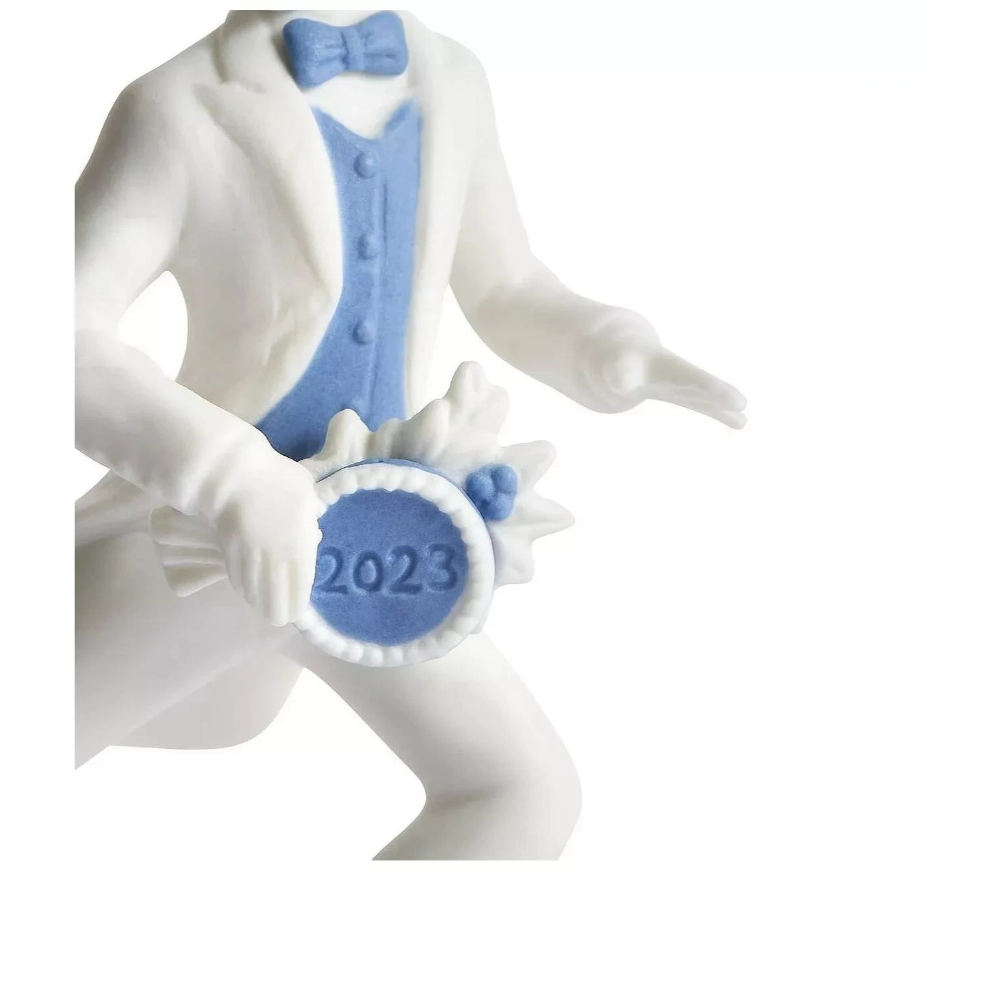 Decorative figurine of a person in a white suit with blue vest