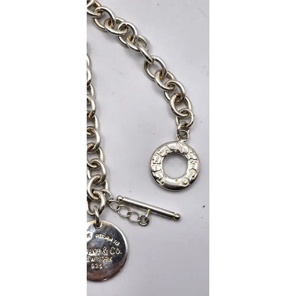 Silver bracelet with a round charm and toggle clasp