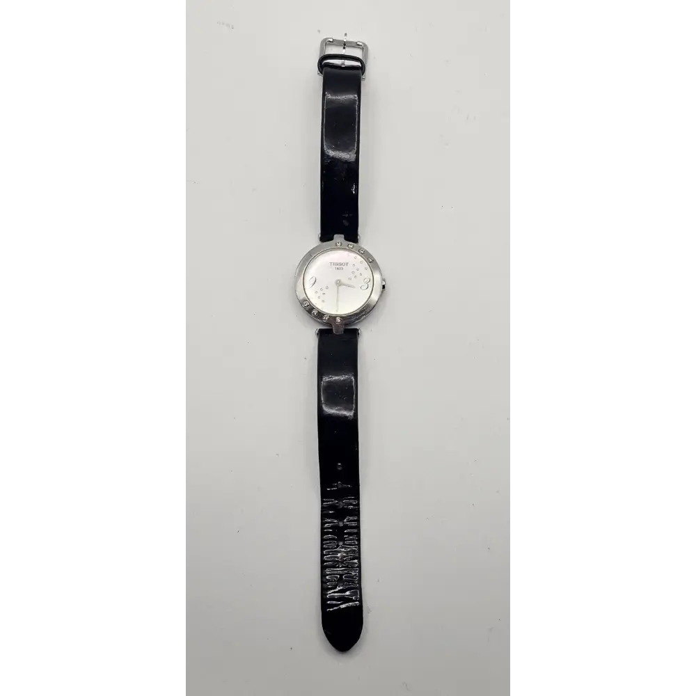 Wristwatch with black strap on a light gray background
