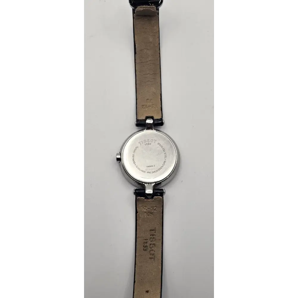 Wristwatch with a brown leather strap on a gray background