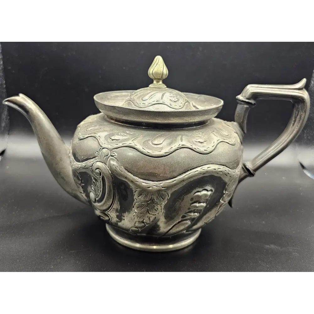 Decorative silver teapot with intricate designs