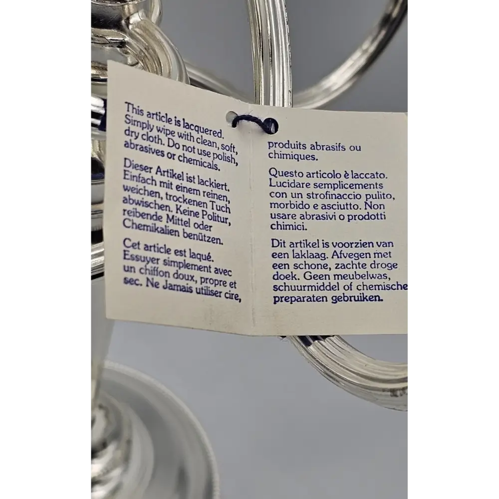 Product label on a silver object with text in multiple languages.
