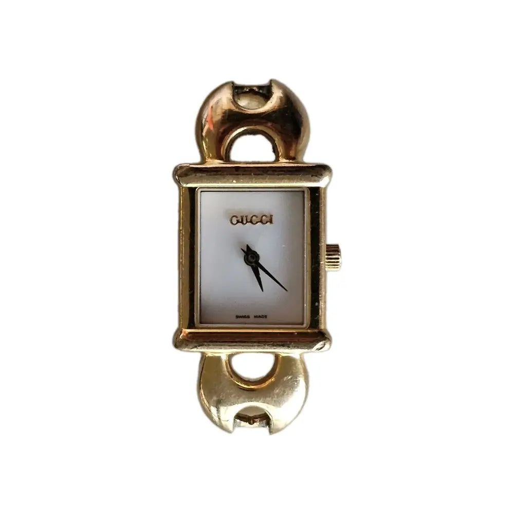 Gold Gucci watch on a white background