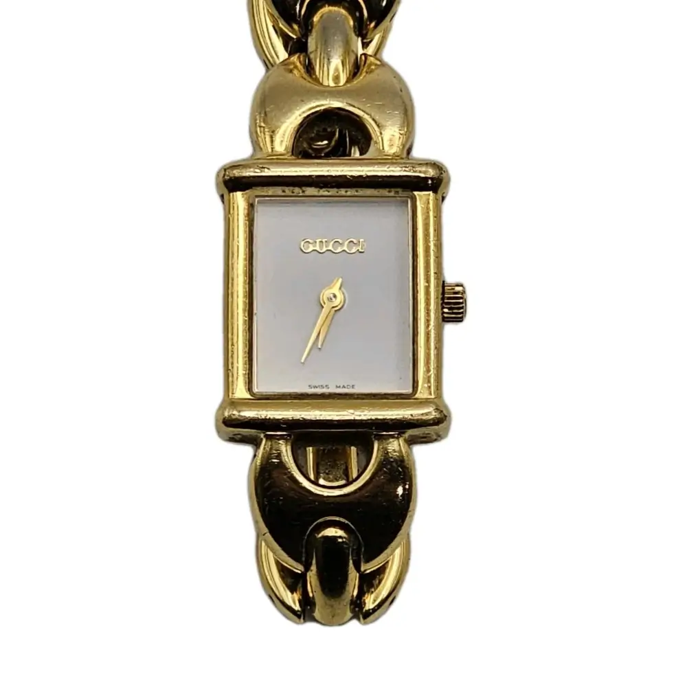 Gold Gucci watch on a white background