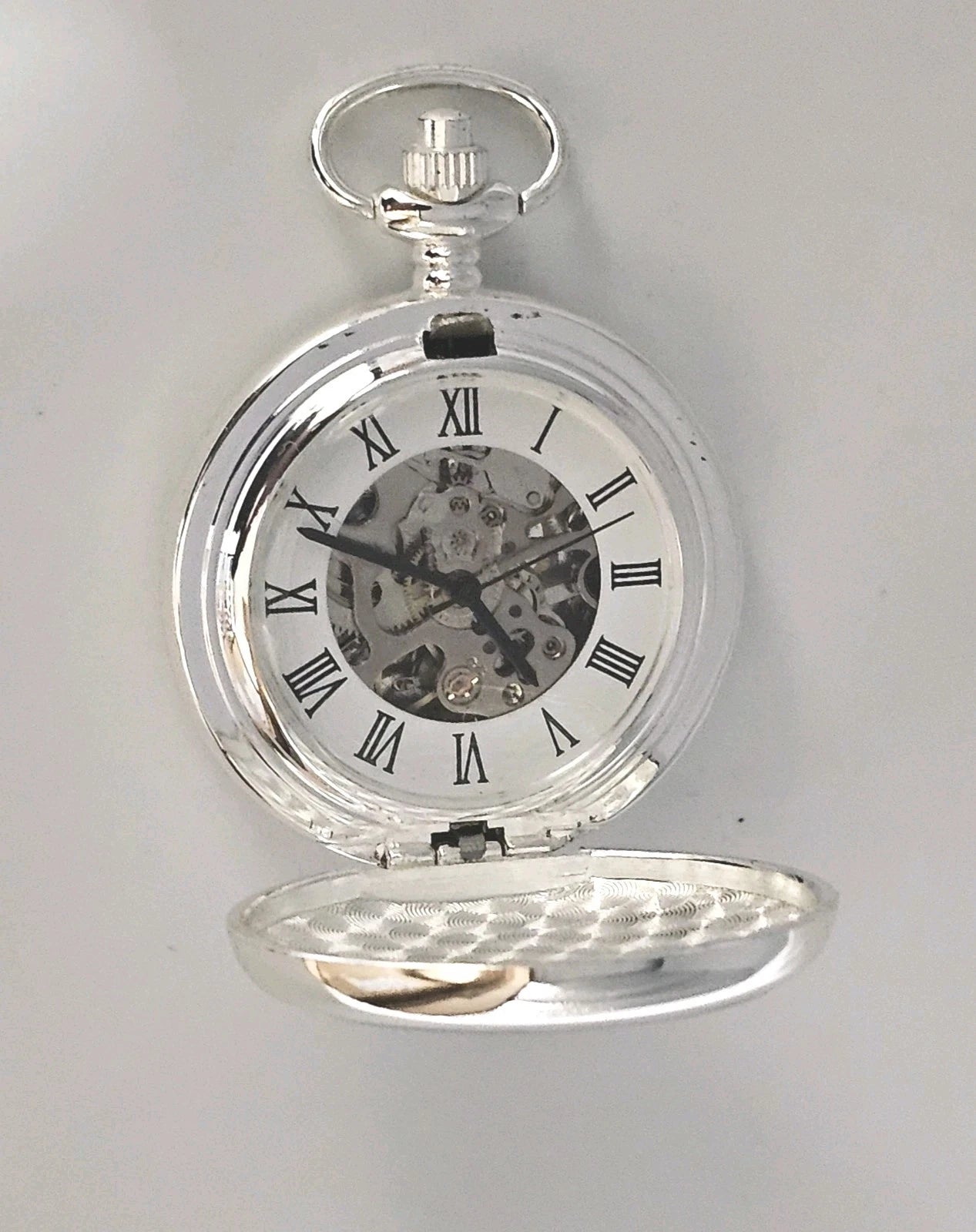 Silver pocket watch with transparent case